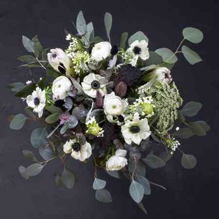Black and white bouquet with white anemones, ranunculus, ornithogalum, ammi visnaga, white allium, veronica, protea, pennisetum, dried black achillea, mixed eucalyptus