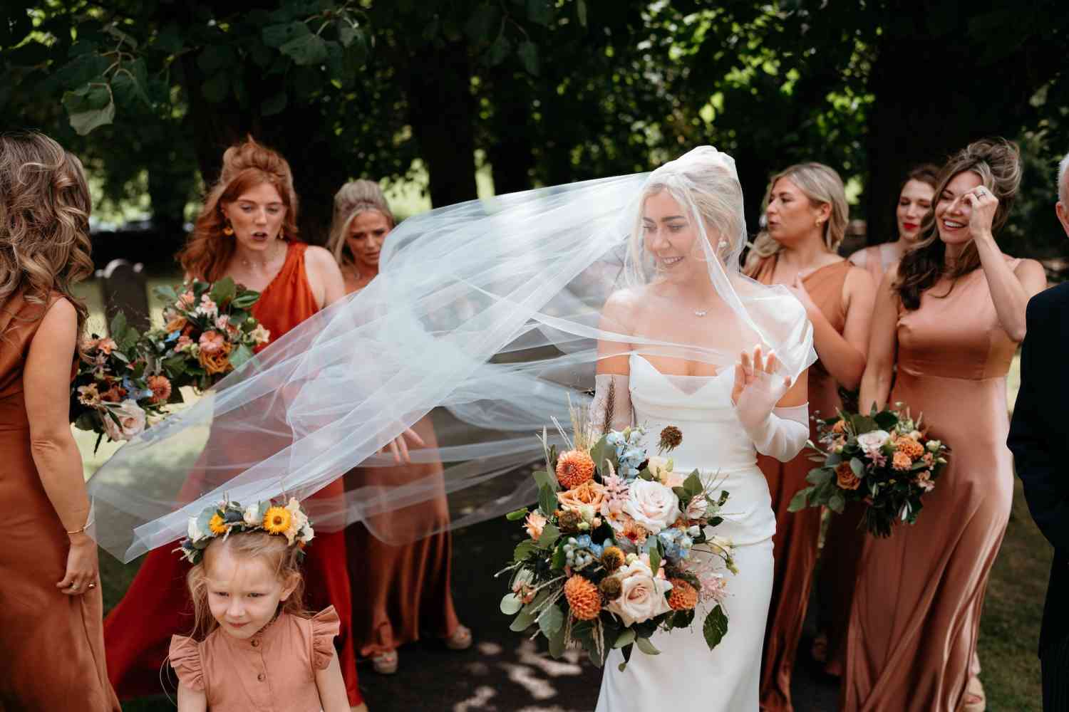 Bridal party bouquets peach roses dahlias blue delphinium garden style wedding copy