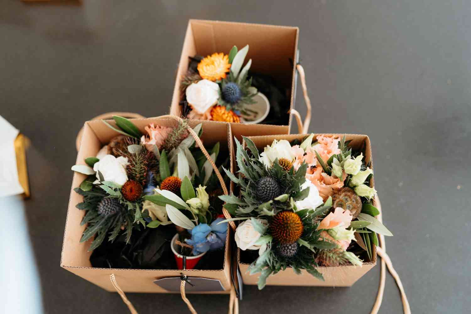 Emily james bridal party bouquets boxed peach roses orange dahlias blue copy