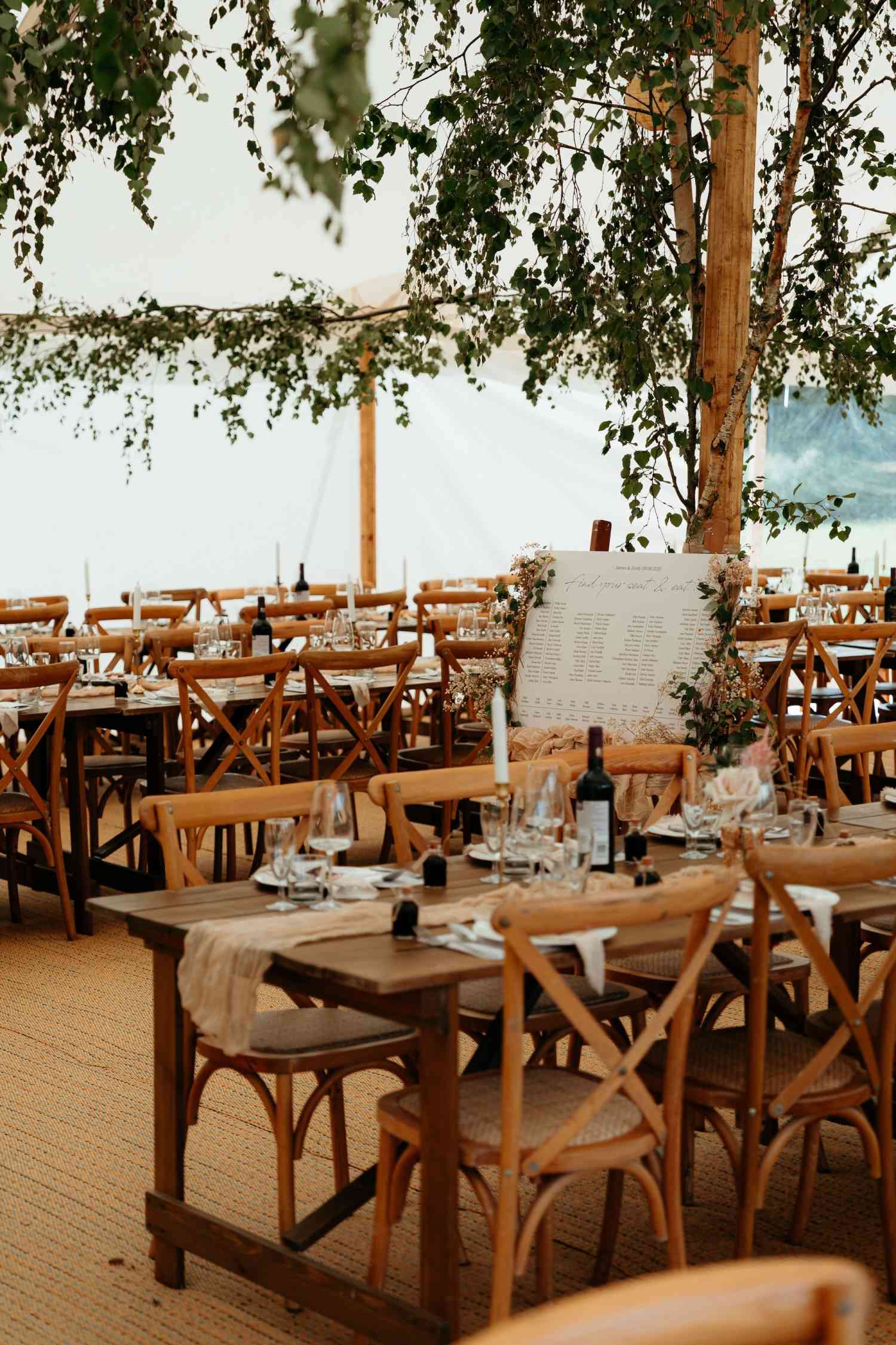Emily jamesoutdoor wedding reception tablescape natural greenery wooden tables copy